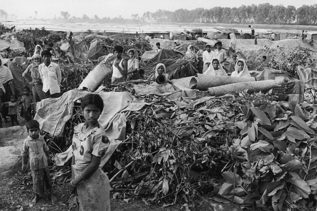 The scene at Dumdumia camp (above), in Cox's Bazar, Bangladesh, shows the lack of adequate shelter. Bangladesh 1992 © Liba Taylor